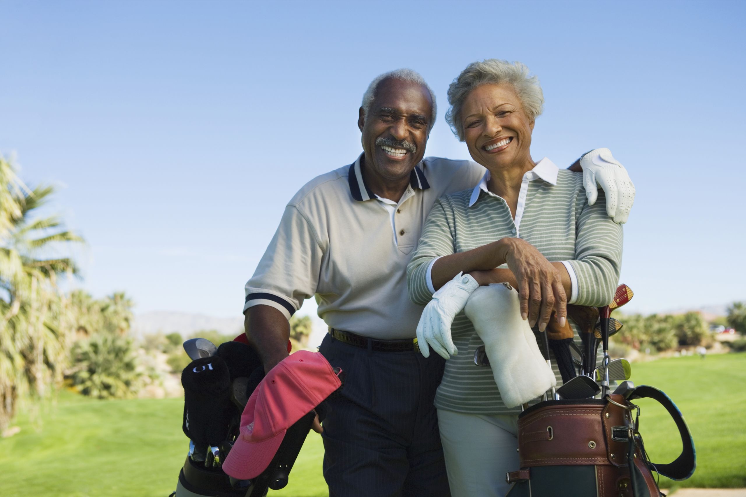 Portrait of happy senior couple in golf course smiling Nevada Part D Annual Enrollment